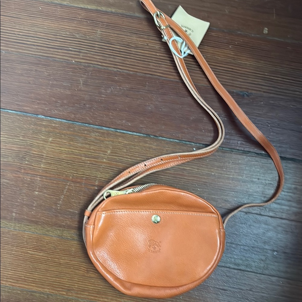 Circular Orange Leather Crossbody Bag with Minimalist Design